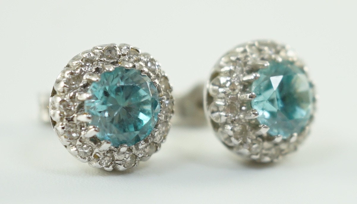 A pair of 18k white gold, blue zircon and diamond set circular cluster ear studs